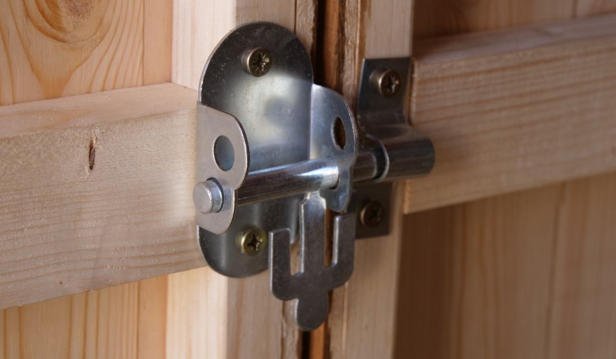 An oval padlock on a shed gate