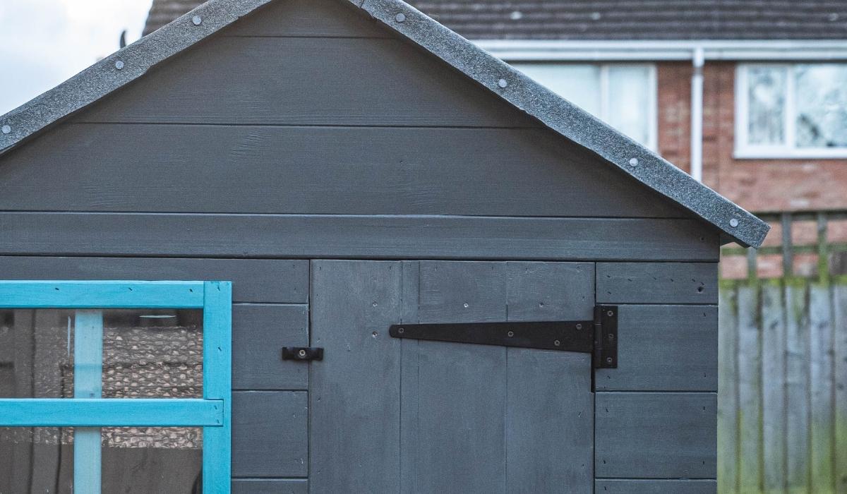 a black hinge on a garden shed