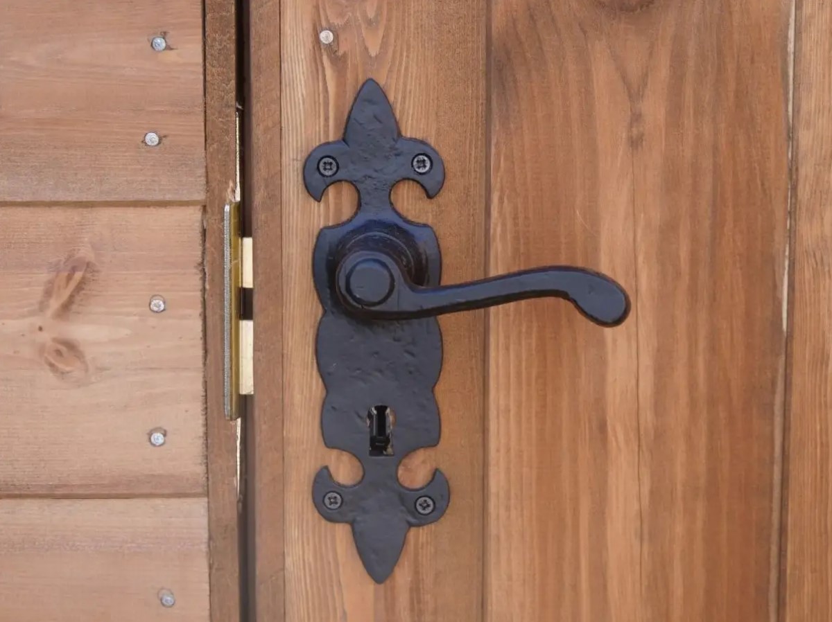 a lever latch door handle on a wooden door