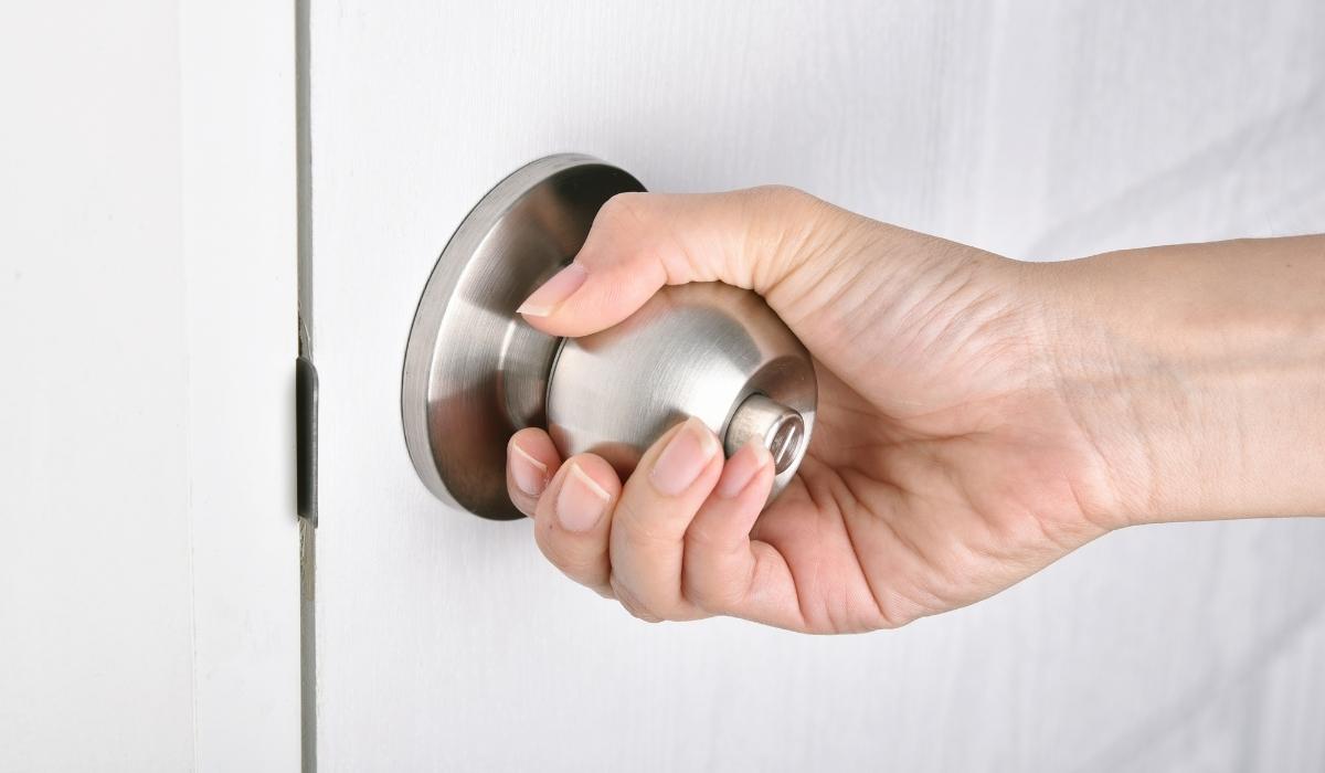 a person opening a door
