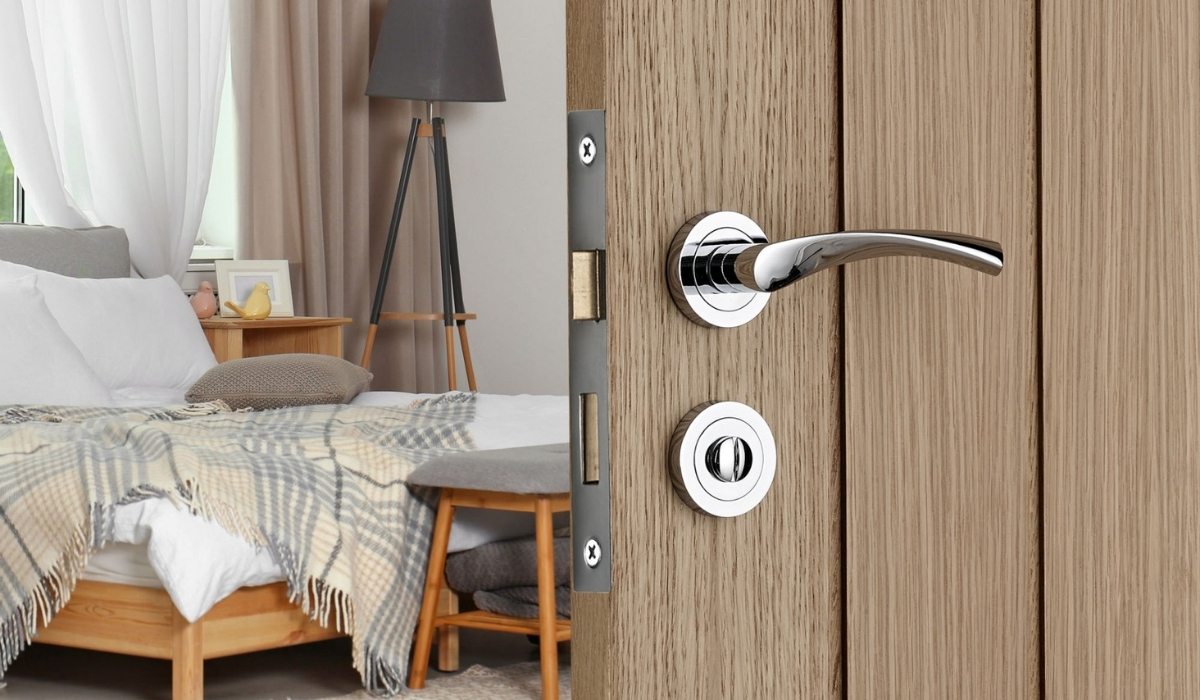 Marcella lever on rose door handle in brushed nickel on a white wooden door