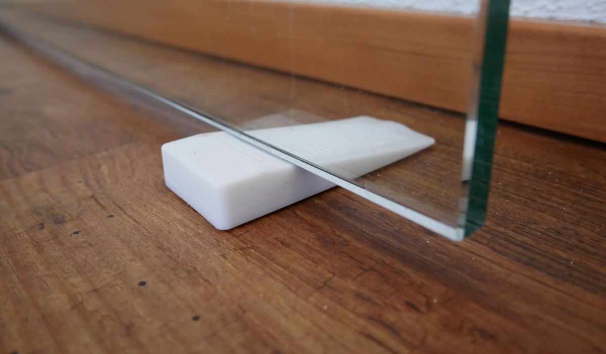 White rubber window wedge used to stop a glass door